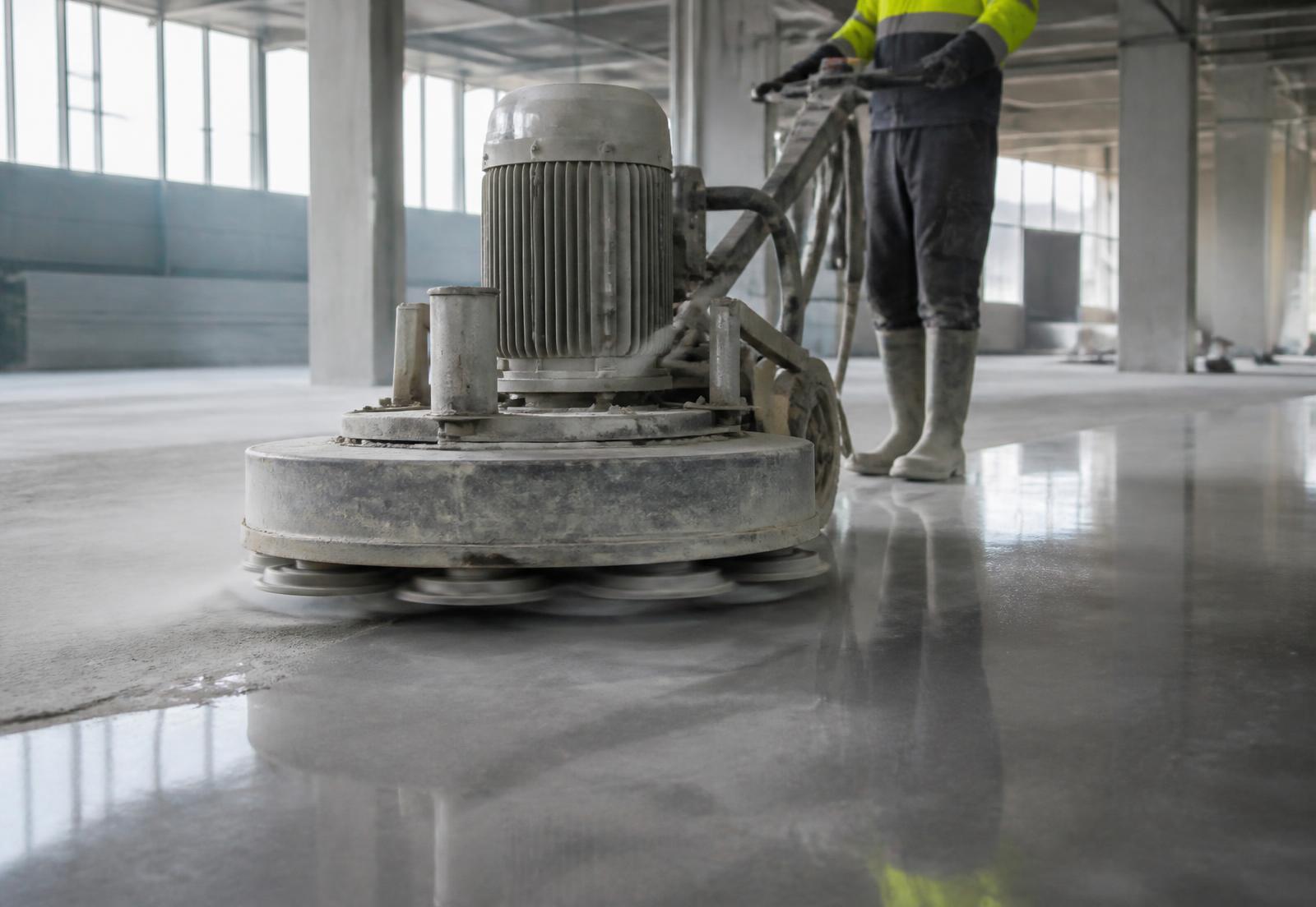Betonplatten schleifen mit Diamantschleifmaschine in einer Industriehalle